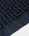 A close-up image of the ONSEN Twilight Blue Waffle Towel on a white background.