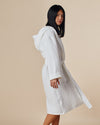 A woman modeling the ONSEN White Waffle Bath Robe.