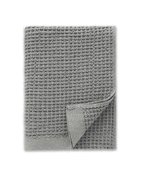 The ONSEN Cinder Grey Waffle Bath Sheet on a white background. 