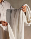 A dressed person holding the ONSEN White Plush Bath Sheet.