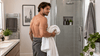 A man using a white towel after bath.
