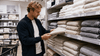 A man checking every towel before buying.
