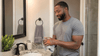 A black man washing his hands.