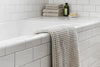 Bath Sheet Vs. Bath Towel: A bath setting with towels and a bath sheet displayed elegantly.