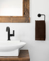 The ONSEN Brown Waffle Hand Towel in a bathroom setting.