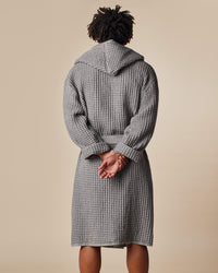 The back view of a man wearing the ONSEN Cinder Grey Waffle Bath Robe.