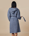 The back view of a woman wearing the ONSEN Denim Waffle Bath Robe.