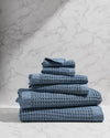 Stack of blue towels on a marble surface