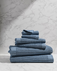 Stack of blue towels on a marble surface