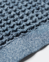 A close-up image of the ONSEN Denim Waffle Bath Towel.