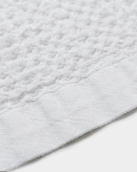 A close-up image of the ONSE White Waffle Bath Towel.