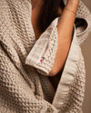 A close-up image of the ONSEN Oatmeal Waffle Bath Sheet wrapped around a woman.