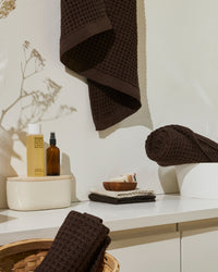 The ONSEN Brown Waffle Towel Set in a bathroom setting.