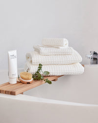 The ONSEN White Waffle Towel Set in a bathroom setting.