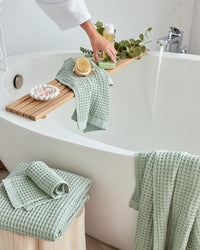 The ONSEN Sage Waffle Bath Towel Set in a bathroom setting.