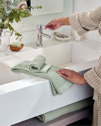 The ONSEN Sage Waffle Bath Towel Set on a bathroom setting.