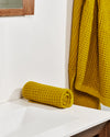 The ONSEN Ochre Waffle Towels in a bathroom setting.