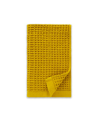The ONSEN Ochre Waffle Hand Towel on a white background.