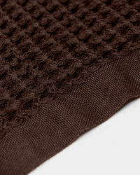 A close-up image of the ONSEN Brown Waffle Towel in a white background.