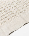A close-up image of the ONSEN Oatmeal Waffle Towel on a white background.