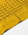 A close-up image of the ONSEN Ochre Waffle Towel on a white background.