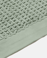 A close-up image of the ONSEN Sage Waffle Bath Towel.